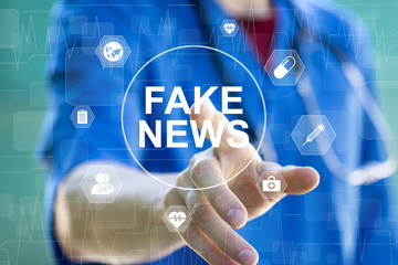 Doctor pressing button Fake News in healthcare on virtual panel medicine