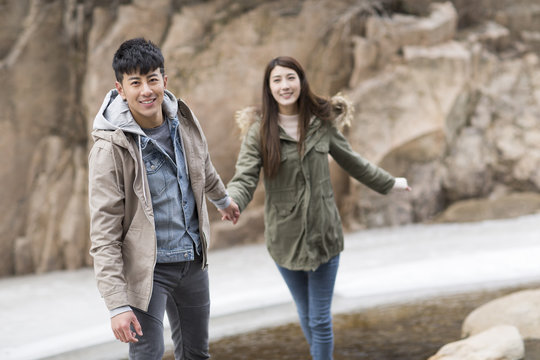 Happy young Chinese couple enjoying winter outing