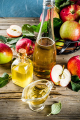 Homemade apple cider vinegar with fresh apples om wooden rustic background copy space
