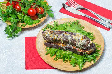 Hot dog in eggplant on lettuce leaves