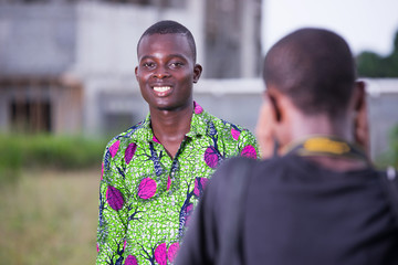 Beautiful young man posing at the camera in a good mood with a p
