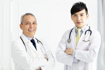 Portrait of two smiling doctors  standing