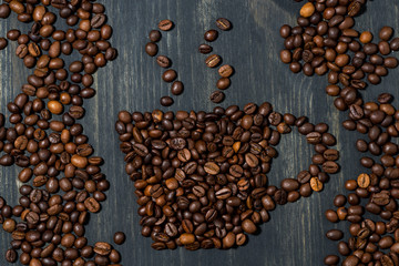 cup of coffee beans on a wooden background, concept photo, closeup