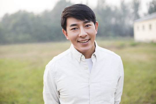 Portrait Of Cheerful Young Chinese Man