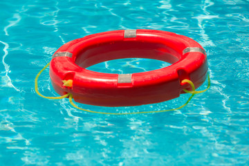 Life-saving buoy floating at the pool
