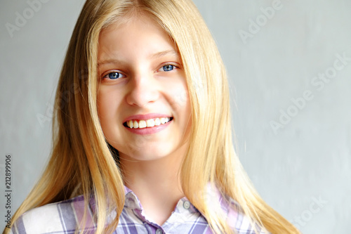 Headshot Of Beautiful Teenage Girl With Blonde Straight Hair Blue