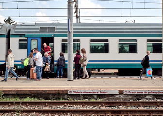 Group of people .get off the locomotive, train station, Santhià, Italy in May 19, 2018