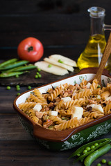 Fusilli pasta with zucchini, goat cheese and green peas