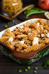Fusilli pasta with zucchini, goat cheese and green peas