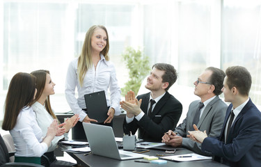 business team applauding the speaker at the meeting.