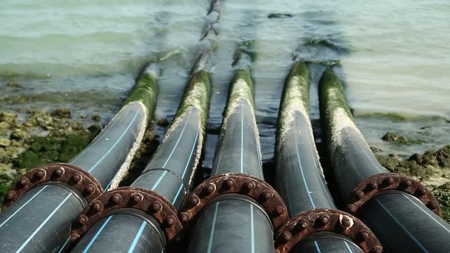 Pipes for intake of sea water and desalination in Doha, Qatar. Desalinization of sea water for city needs, water intake from Persian Gulf, Arabian Peninsula