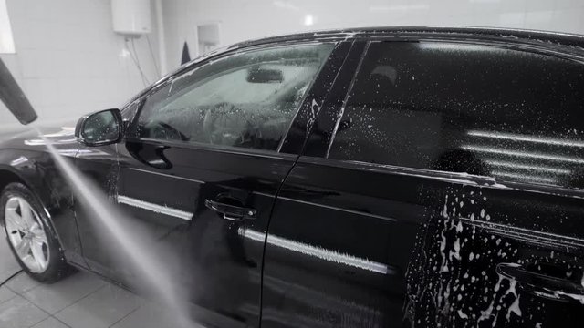 Black auto in car wash