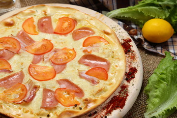 Pizza thin with sausage, bacon, spices