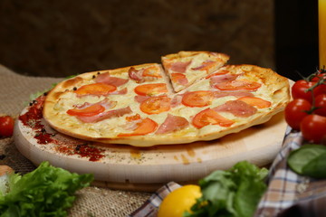 Pizza thin with sausage, bacon, spices