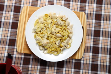 Macaroni of Carbonara with smoked sausage, bacon, sauce. Tasty lunch in the Italian restaurant with herbs, dill