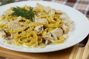 Macaroni of Carbonara with smoked sausage, bacon, sauce. Tasty lunch in the Italian restaurant with herbs, dill