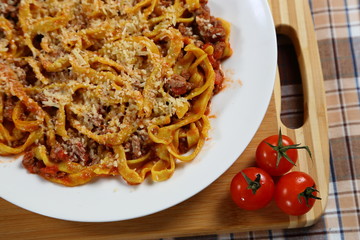 Macaroni with tomato sauce, spices and dark. Italian Cuisine.