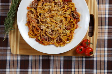 Macaroni with tomato sauce, spices and dark. Italian Cuisine.