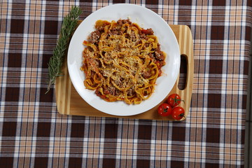 Macaroni with tomato sauce, spices and dark. Italian Cuisine.