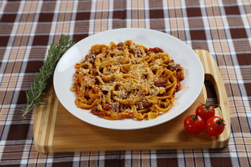 Macaroni with tomato sauce, spices and dark. Italian Cuisine.