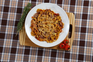 Macaroni with tomato sauce, spices and dark. Italian Cuisine.