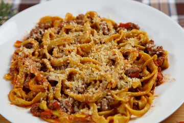 Macaroni with tomato sauce, spices and dark. Italian Cuisine.