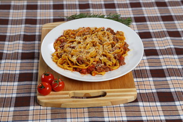 Macaroni with tomato sauce, spices and dark. Italian Cuisine.