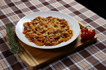 Macaroni with tomato sauce, spices and dark. Italian Cuisine.