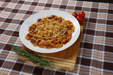 Macaroni with tomato sauce, spices and dark. Italian Cuisine.