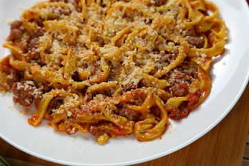Macaroni with tomato sauce, spices and dark. Italian Cuisine.