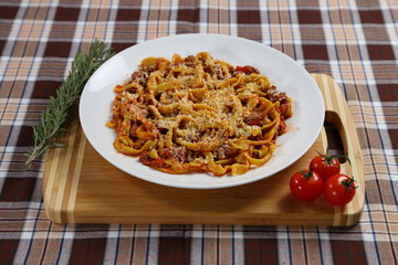 Macaroni with tomato sauce, spices and dark. Italian Cuisine.