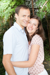 smiling happy couple in garden in nlove hug together