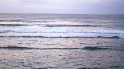 Uluwatu. Surfers surfing in ocean. Number four surf destination in the world for surfers of all abilities. slow motion, Bali, Indonesia. 3840x2160