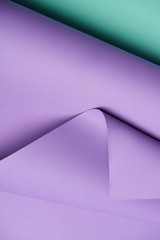 close-up view of beautiful violet and turquoise abstract paper background