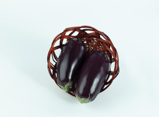 view from the top.two ripe eggplant in a wicker basket.isolated 