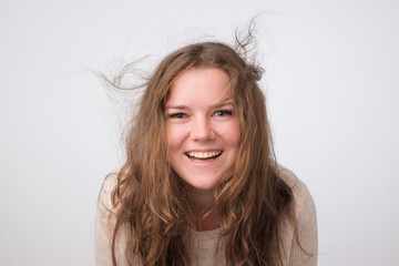 Laughing caucasian plump girl with natural make up looking at camera. Close up photo studio shoot. She is enjoying life. Positive mind and facial emotion