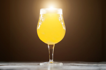 Glass beer with foam on black background with copyspace