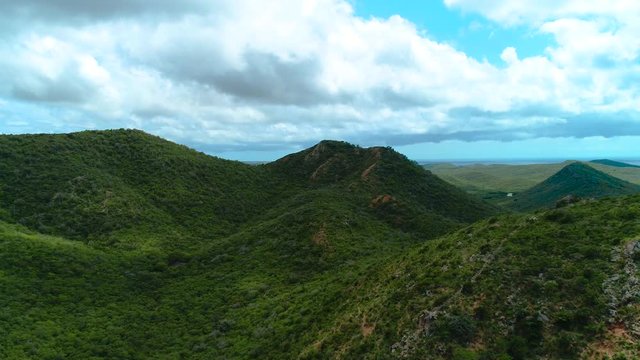 Aerial Drone Shot of Tropical Green Hills and Blue Skies