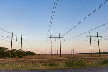 Fototapeta na wymiar power lines on sunset background