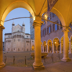 Modena - The porticoes on the Piazza Grande square at dusk with the Dome.