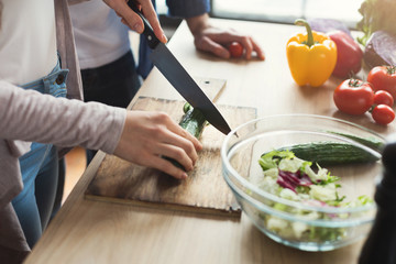 Obraz na płótnie Canvas Closeup of couple cooking healthy food together