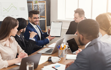 Businessman showing annual report to his colleagues