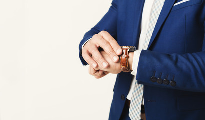 Businessman checking time on watch, copy space