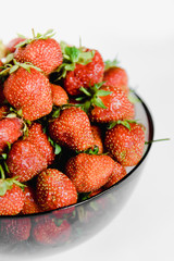fresh strawberries in a plate on a white background