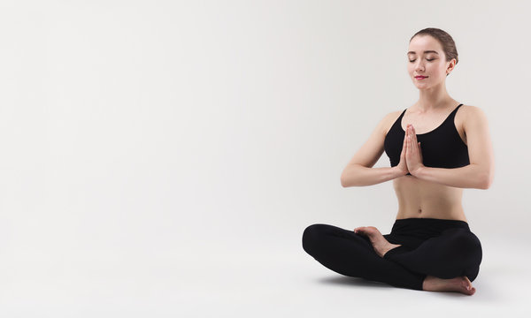 Beautiful woman doing yoga lotus pose