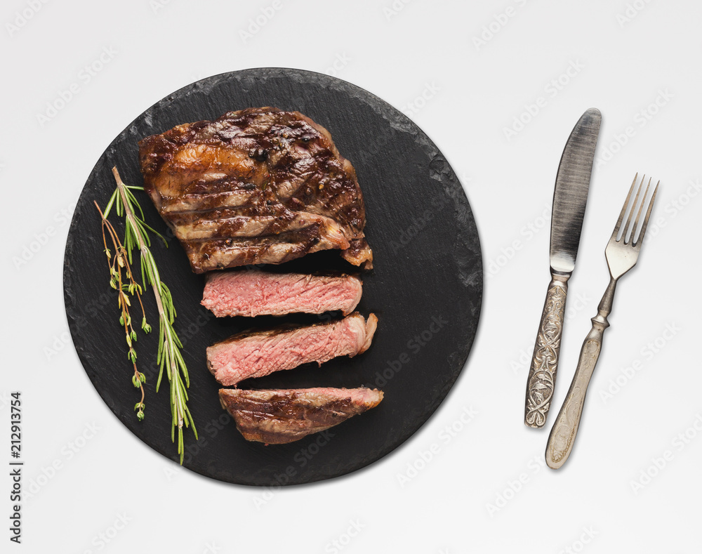 Wall mural rib eye steak and spices on white isolated background