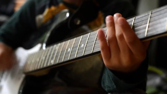 a boy play the guitar