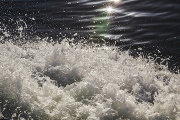 water spray forms on the side of the ship