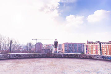 Fototapeta premium Rear view young man standing getting away from it all - peace and quiet, solitude, independence concept