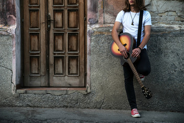 Young man holding acoustic guitar